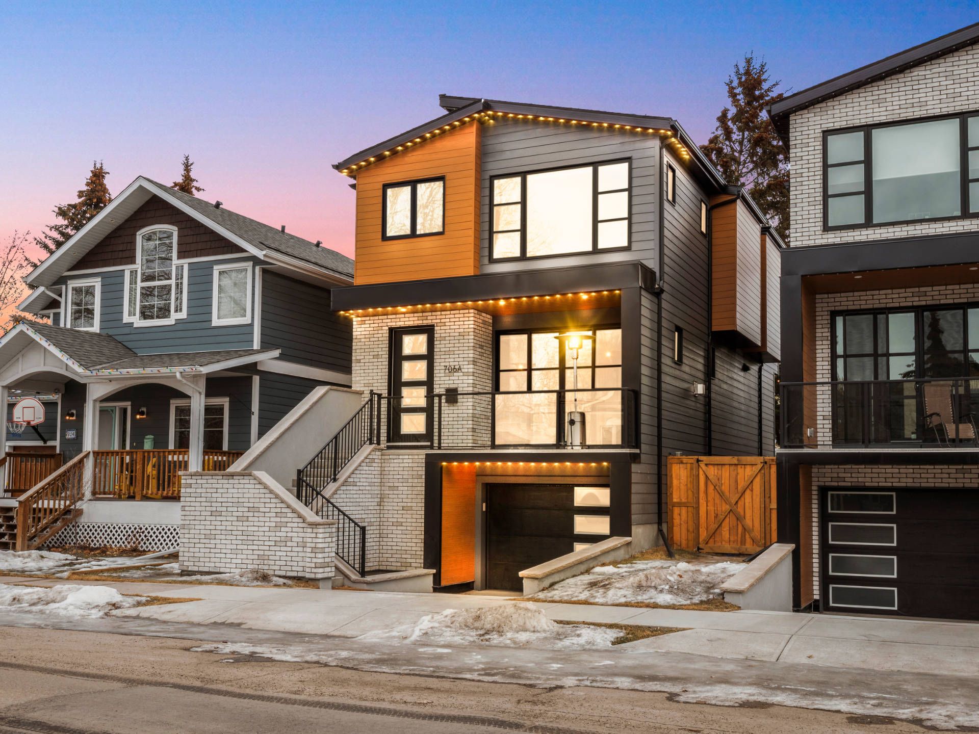 Modern infill homes with mixed wood and stone exteriors